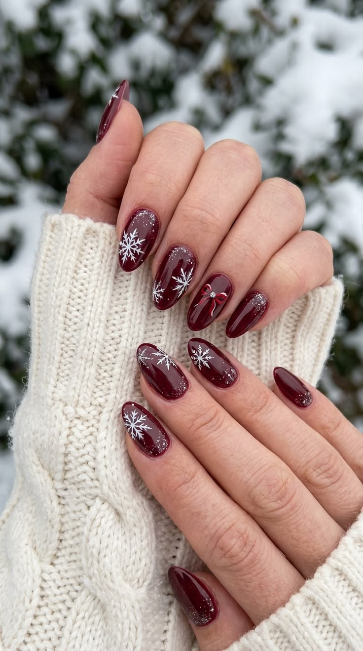 20 Stunning Winter Nail Designs That’ll Make Your Hands the Star of Every Holiday Party - 11. Oxblood Snowflakes and a Tiny Bow 1