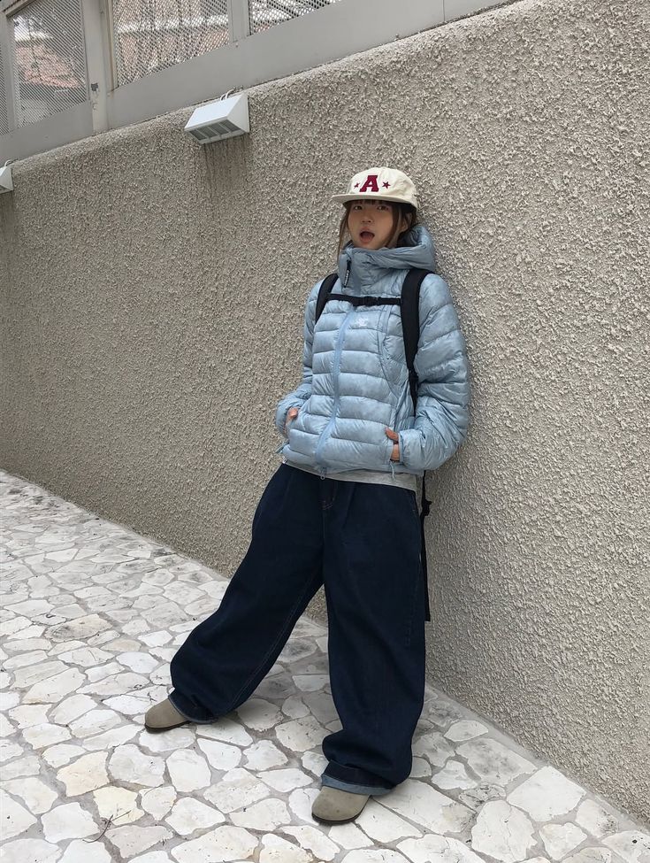 Puffer Jacket Outfits: 20 Ways to Look Chic in the Cold - 02. Icy Blue, Wide-Leg Denim, and a Sporty Cap 1