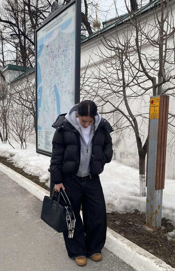 Puffer Jacket Outfits: 20 Ways to Look Chic in the Cold - 07. Snow-Day Black Puffer with Wide Jeans 1